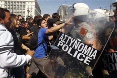 High-school students clash with riot police during a protest march against economic austerity and planned education reforms in Athens