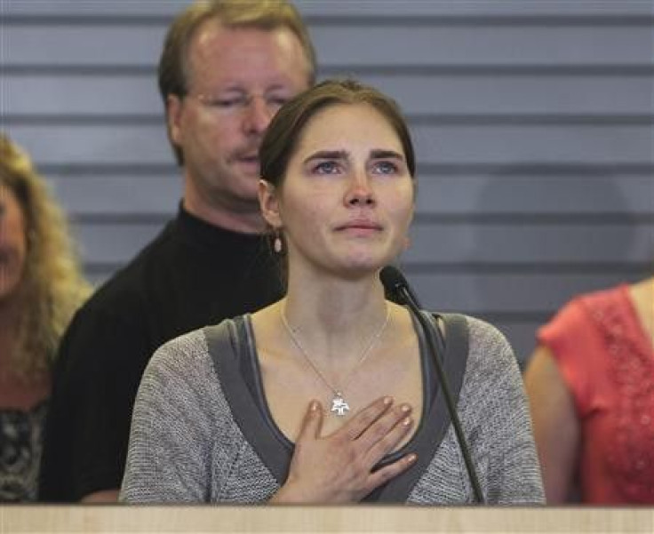Amanda Knox pauses emotionally while speaking during a news conference at Sea-Tac International Airport, Washington after landing there on a flight from Italy