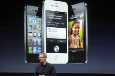 Apple CEO Tim Cook speaks in front of an image of an iPhone 4S at Apple headquarters in Cupertino, California 