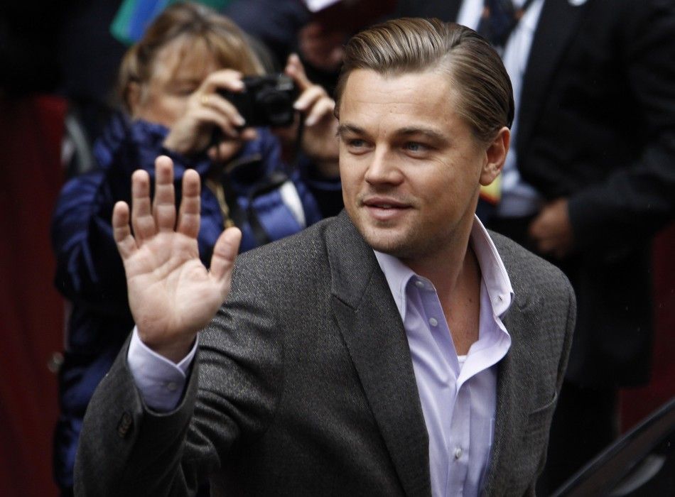 Actor DiCaprio waves to supporters as he arrives for a photocall to promote the movie quotShutter Islandquot at Berlinale in Berlin