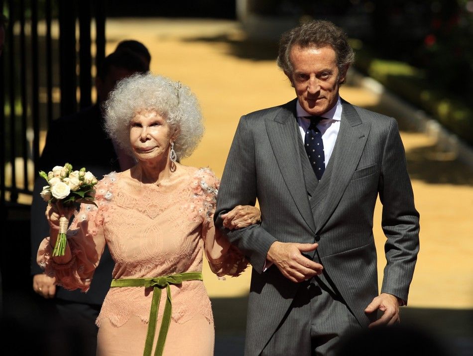Spains Duchess of Alba Cayetana Fitz-James Stuart y Silva and her husband Alfonso Diez pose at the enrance of Las Duenas Palace after their wedding in Seville