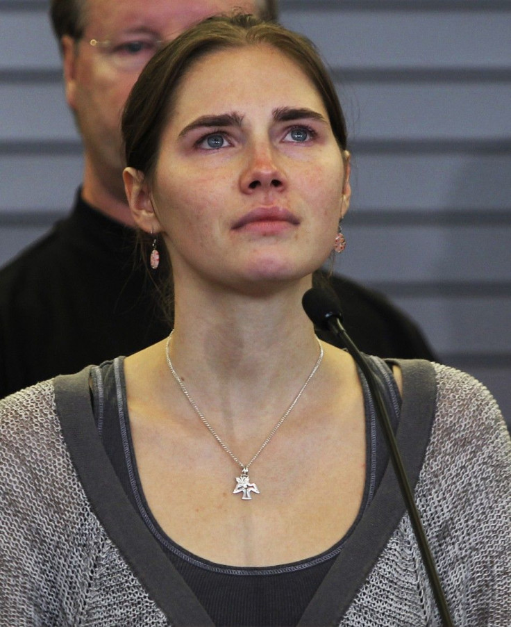 Amanda Knox pauses while speaking during a news conference at Sea-Tac International Airport