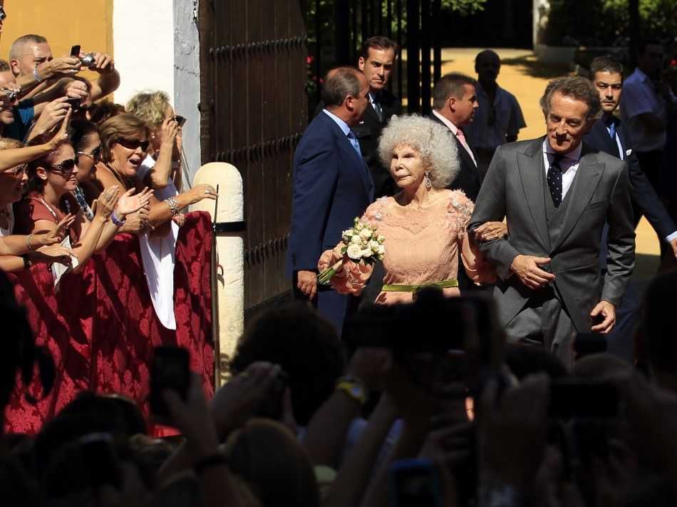 Spains Duchess of Alba Cayetana Fitz-James Stuart y Silva and her husband Alfonso Diez pose at the enrance of Las Duenas Palace after wedding in Seville