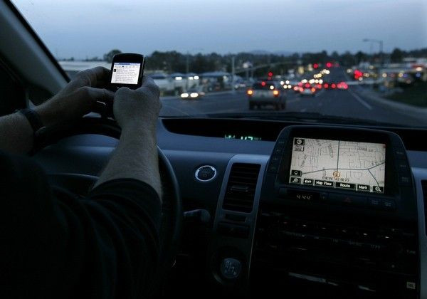 A driver uses his smart phone while in traffic in Encinitas, California December 10, 2009.