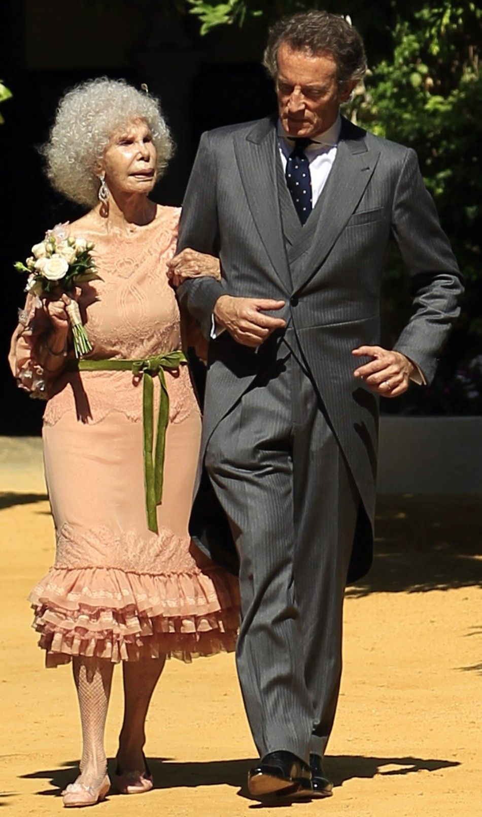 Spains Duchess of Alba Cayetana Fitz-James Stuart y Silva L and her husband Alfonso Diez walk inside Las Duenas Palace after their wedding in Seville