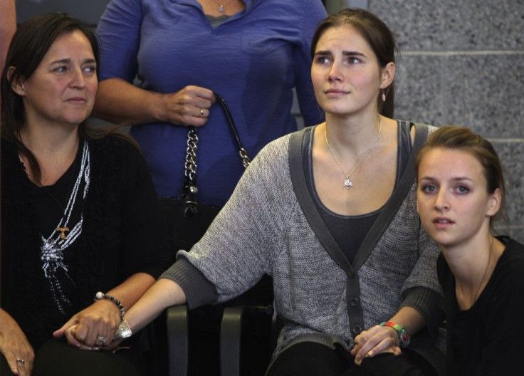 Knox holds hands with her mother Mellas and her younger sister at Sea-Tac International Airport, Washington