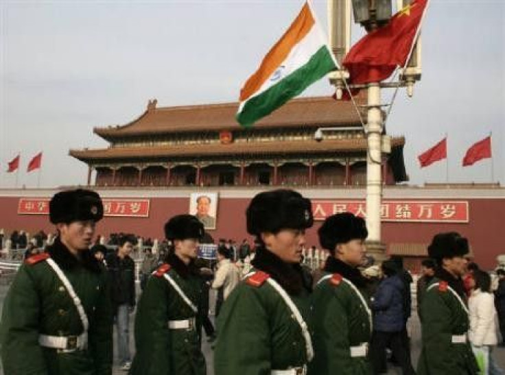 Chinese paramilitary policemen walk past an Indian flag in front of Tiananmen Gate in Beijing in this January 13, 2008 file photo. The emerging Asian giants of China and India may be locked in a battle for economic supremacy, but on the sporting front at 