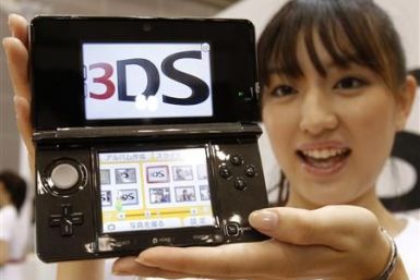 Model poses with Nintendo Co Ltd's new 3DS handheld game console in Chiba
