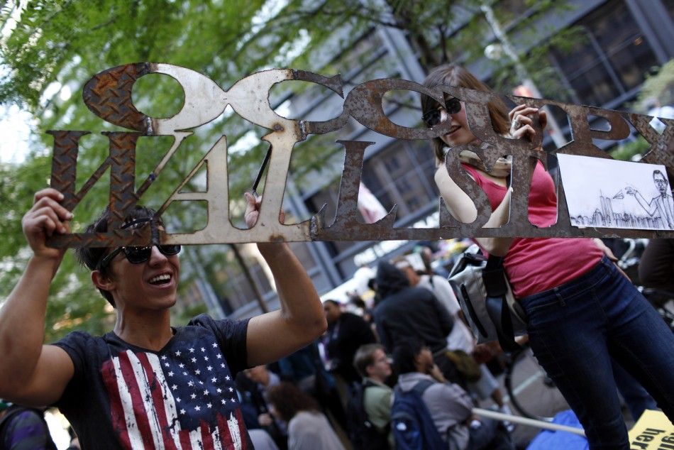 A couple holds a welded iron quotOccupy Wall Streetquot sign as they demonstrate in New York City