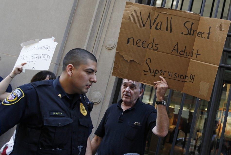 A protestor demonstrates in support of the New York Occupy Wall Street protests in front of the Federal Reserve Bank of Chicago in the citys financial district
