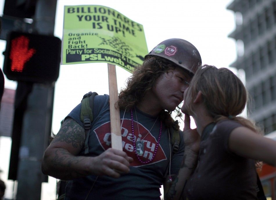 A couple kisses during a march in support of the New York Occupy Wall Street protests outside City Hall in Los Angeles, California
