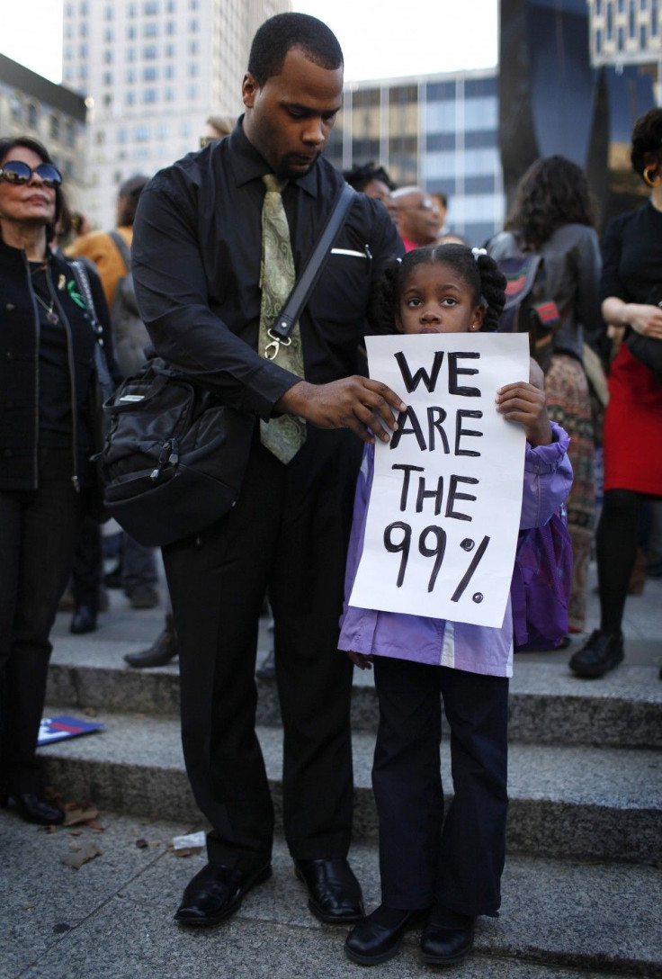 A man and his daughter join Occupy Wall Street and union protesters in Foley Square in New York City