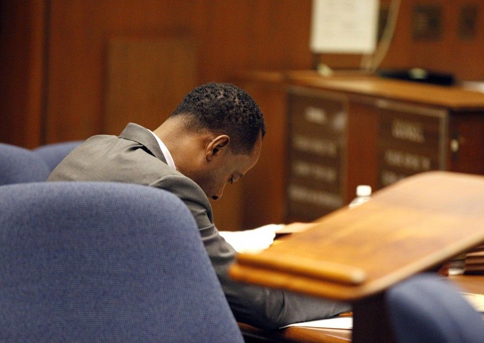 Dr. Conrad Murray looks down at the defense table during trial in the death of pop star Michael Jackson in Los Angeles