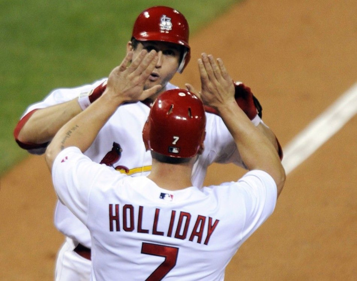St. Louis Cardinals&#039; Freese and Holliday celebrate after hitting a home run against Philadelphia Phillies during their MLB Divisional Series playoffs in St. Louis