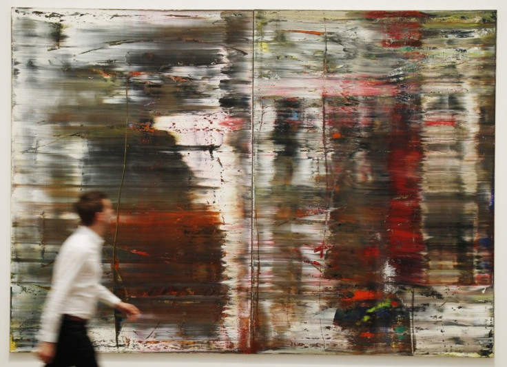 Employee Duncam Holden poses for a photograph with Gerhard Richter&#039;s artwork Abstract Painting Abstraktes Bild (CR:726) at the press launch of the new exhibition Gerhard Richter : Panorama at the Tate Modern gallery in London