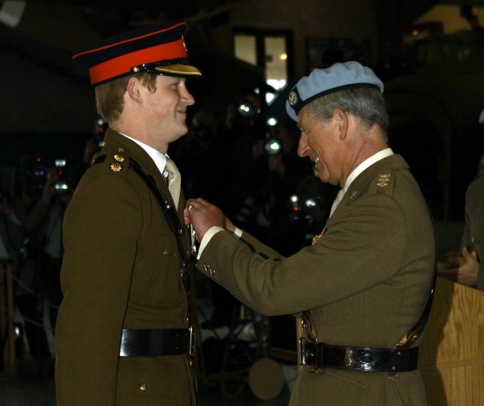 Britains Prince Harry smiles as he receives his wings from his father Prince Charles at the Army Aviation Centre at Middle Wallop