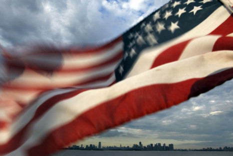 A U.S. flag flutters over top of the skyline of New York and Jersey City as seen from Bayonne, New Jersey