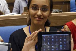 Indian students display Aakash after its launching ceremony in New Delhi. Aakash sells for $60 or $35 with government subsidies, and aims to provide tablets to the masses.