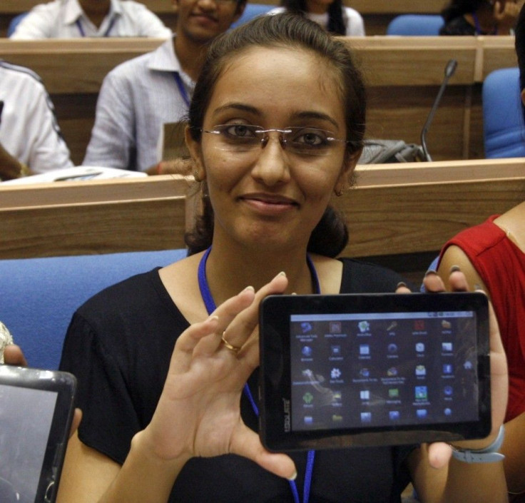 Indian students display Aakash after its launching ceremony in New Delhi. Aakash sells for $60 or $35 with government subsidies, and aims to provide tablets to the masses.