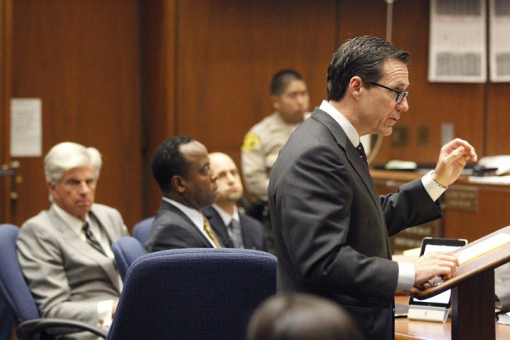 Deputy district attorney David Walgren holds Dr. Conrad Murray's iPhone which was entered as evidence during Murray's trial in Los Angeles