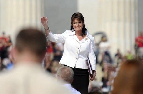 Palin greets the crowd as she stands on the steps in front of the Lincoln Memorial to address supporters at Becks Restoring Honor rally on the National Mall in Washington