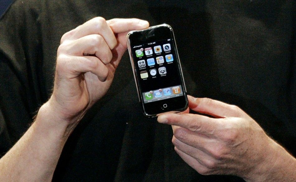 Apple Chief Executive Officer Steve Jobs holds the new iPhone in San Francisco