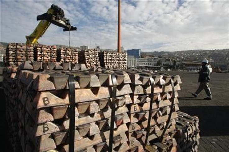 A security guard walks past a shipment of copper in a file photo.