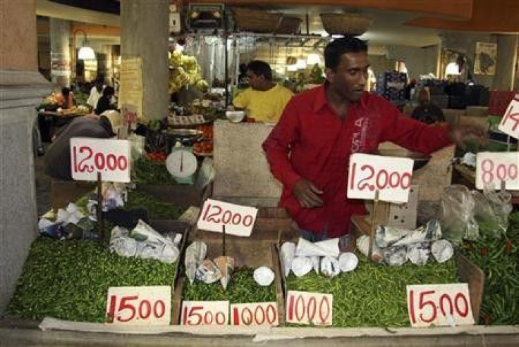 A vendor sells chillies at a food market in Port Louis