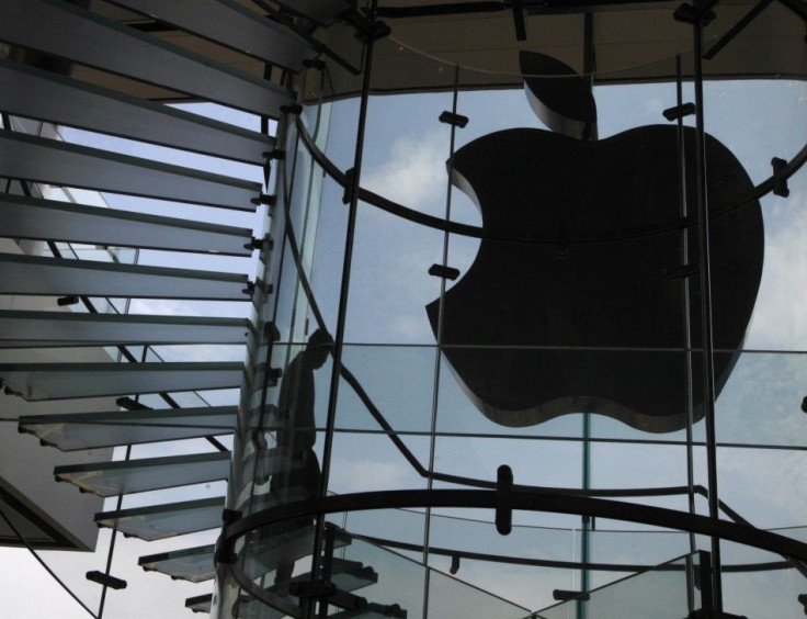 An Apple logo's light is switched off to mourn the death of ex-CEO Steve Jobs in an Apple Store in Hong Kong. Apple shares fell slightly Thursday, one day after Jobs' death.