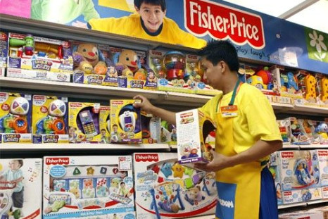 An employee arranges Fisher-Price toys at a store
