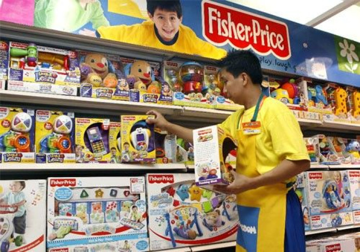 An employee arranges Fisher-Price toys at a store