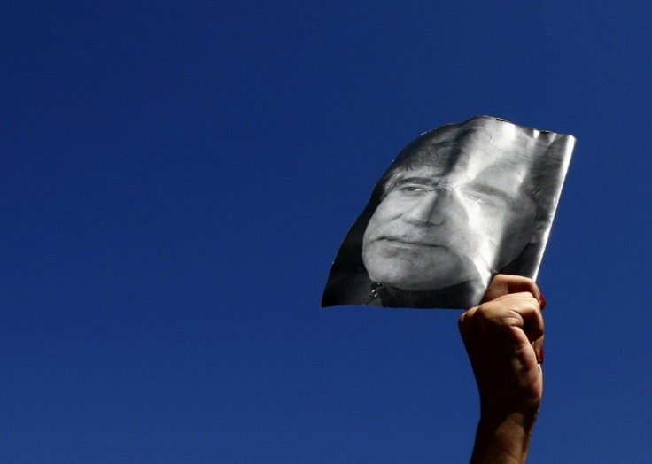 A demonstrator holds up a portrait of the late Turkish- Armenian writer Hrant Dink in Istanbul