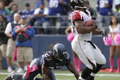 Falcons&#039; Turner breaks free from Seahawks&#039; Bigby and runs for a 21-yard touchdown during their NFL football game in Seattle