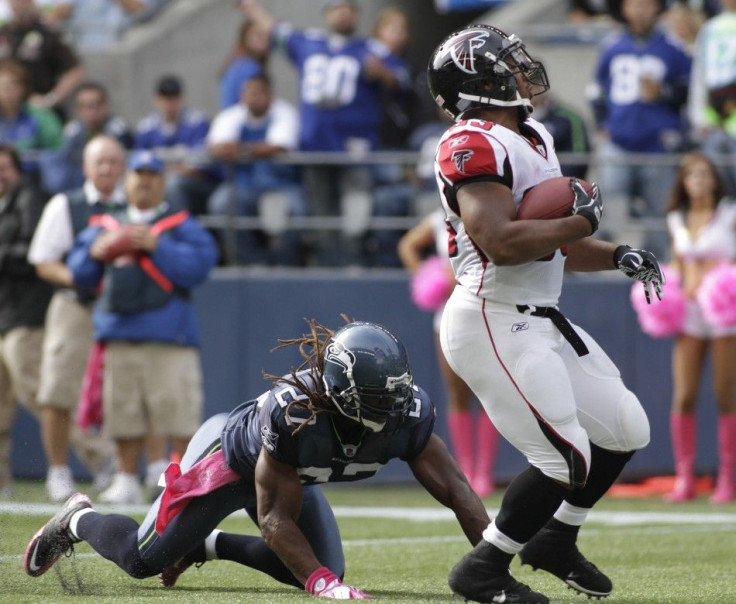 Falcons&#039; Turner breaks free from Seahawks&#039; Bigby and runs for a 21-yard touchdown during their NFL football game in Seattle