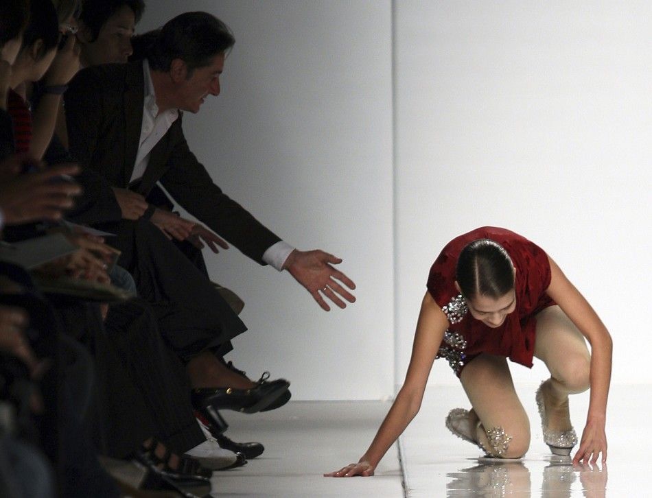 A model falls as she displays a creation as part of Mila Schon SpringSummer 2010 women039s collection during Milan Fashion Week