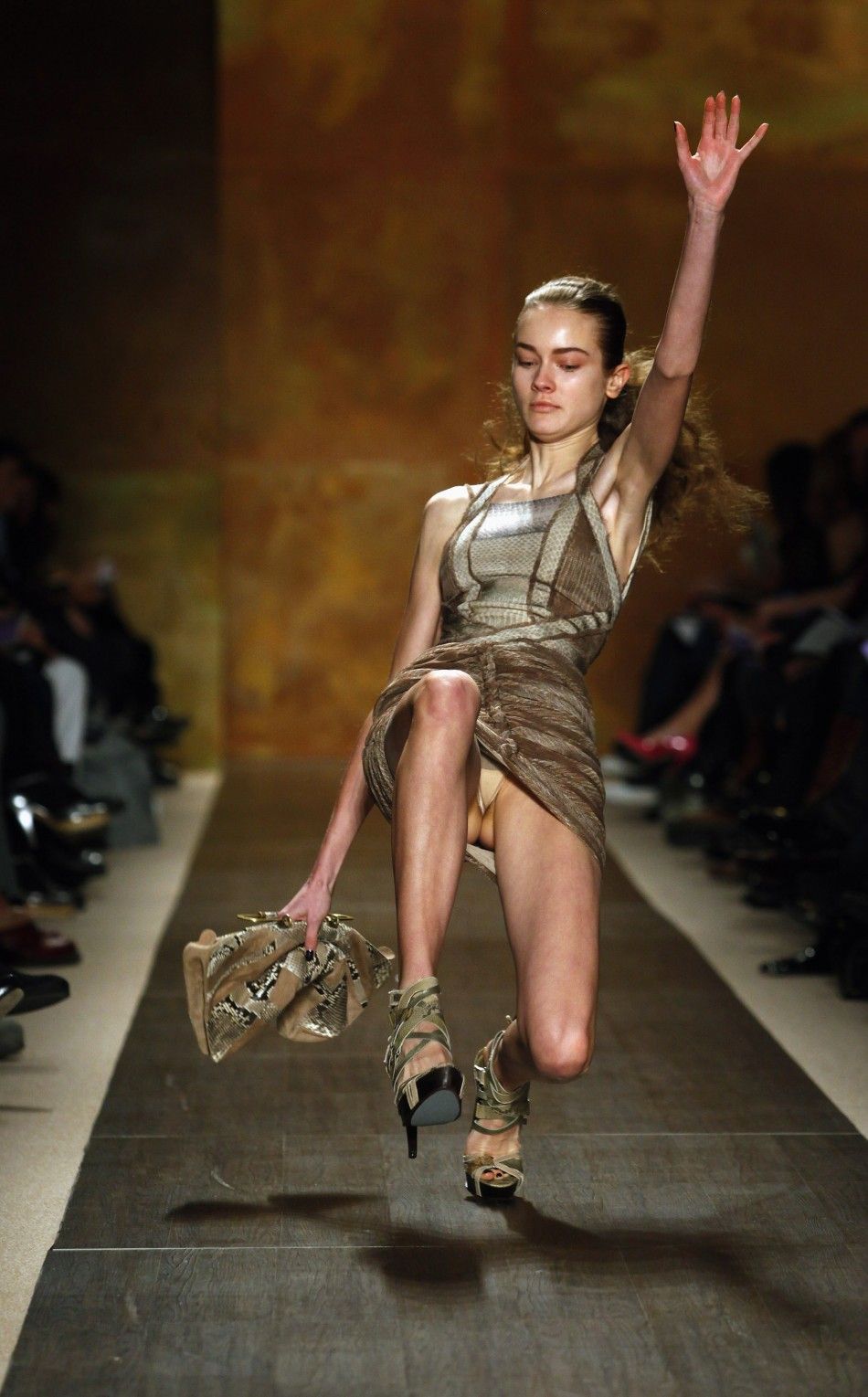 A model slips and falls while presenting a creation from the Herve Leger by Max Azria Fall 2009 collection during New York Fashion Week in New York