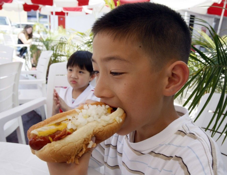 Martin Nguyen takes a bite of a hot dog at Pink&#039;s in Hollywood, California