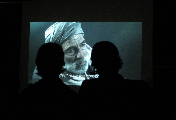 Afghans watch a movie at the French cultural center during the first Autumn Human Rights Film Festival in Kabul