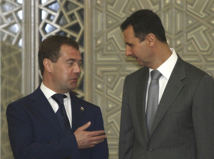 Russia&#039;s President Dmitry Medvedev chats with Syria&#039;s President Bashar al-Assad before a news conference in Damascus