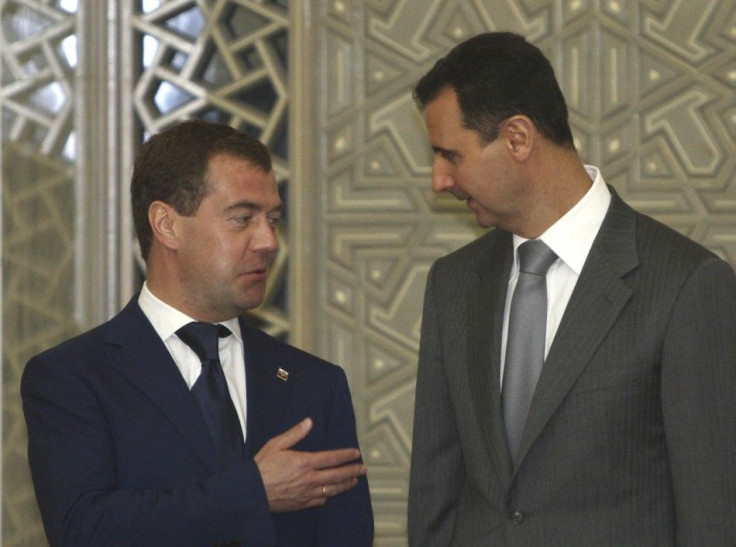 Russia's President Dmitry Medvedev chats with Syria's President Bashar al-Assad before a news conference in Damascus