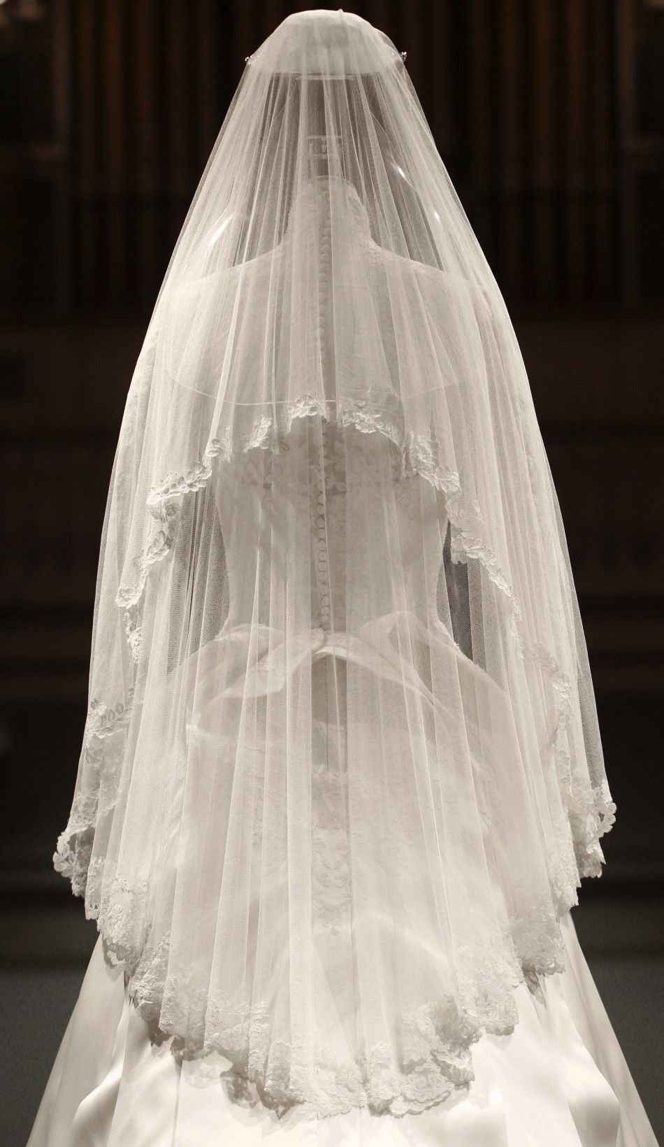 The wedding dress of Britains Catherine, Duchess of Cambridge is seen as it is prepared for display at Buckingham Palace in London