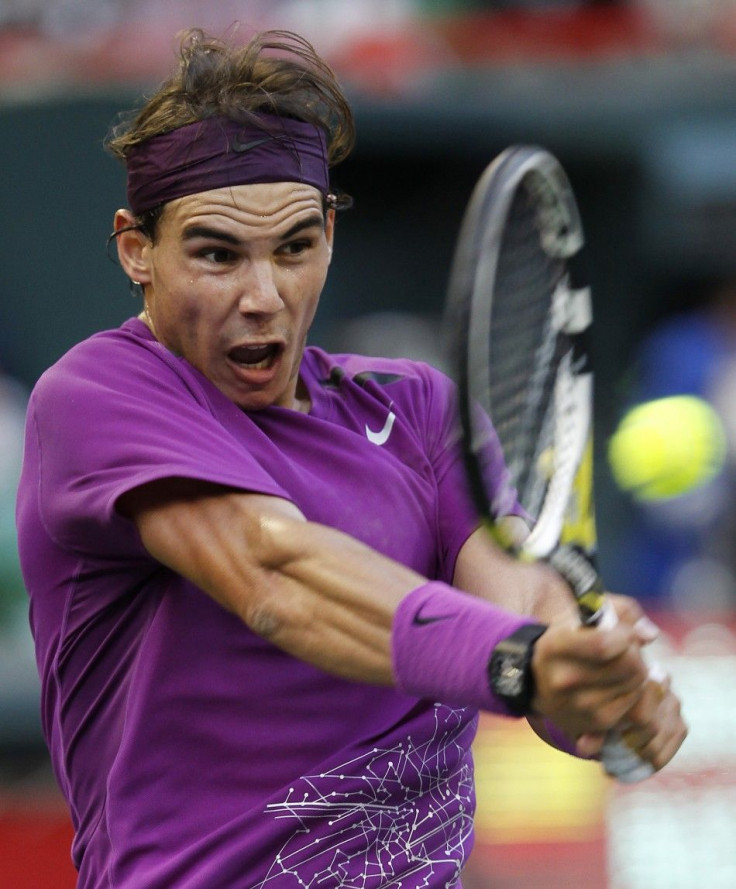 Nadal of Spain hits a return to Giraldo of Columbia during their men&#039;s singles quarter-final match at the Japan Open tennis championships