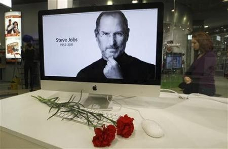 Carnations are placed before a computer screen showing a portrait of Apple co-founder and former CEO Steve Jobs at an Apple store in St. Petersburg
