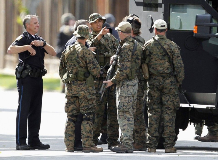 Police officers prepare to sweep a suburban street during a manhunt in Sunnyvale