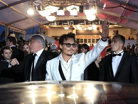 Cast member Johnny Depp leaves the Festival Palace after the screening of the film ''Pirates Of The Caribbean: On Stranger Tides'' at the 64th Cannes Film Festival