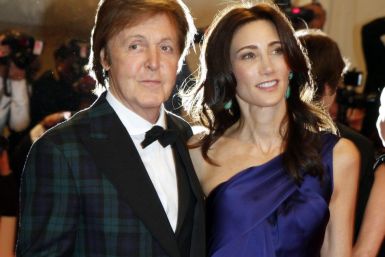 Nancy Shevell and Paul McCartney pose on arrival at the Metropolitan Museum of Art Costume Institute Benefit celebrating the opening of Alexander McQueen: Savage Beauty in New York