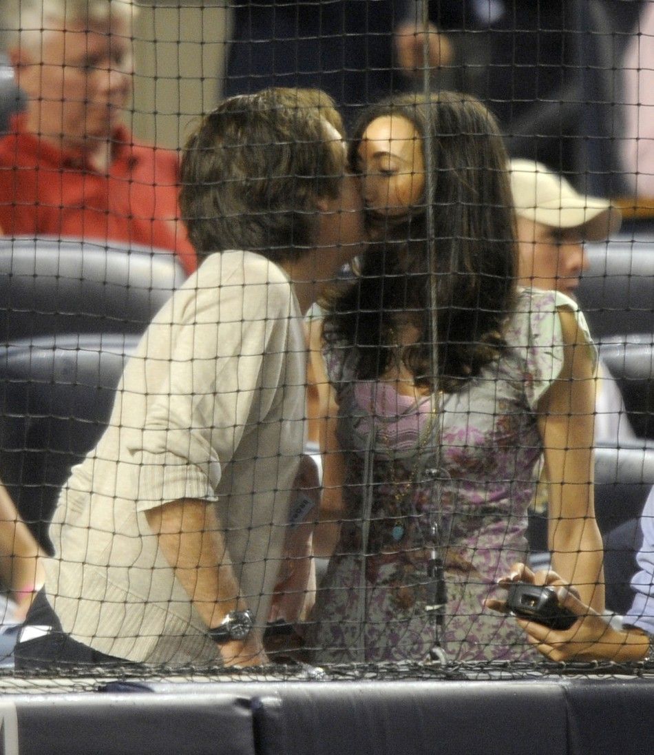 Former Beatle Paul McCartney and Nancy Shevell, an MTA Board member, share a kiss as she leaves the MLB American League baseball game between the New York Yankees and the Texas Rangers at Yankee Stadium in New York 