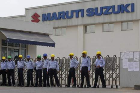 Private security guards stand outside the main entrance to the Maruti Suzuki India Limited plant where workers are striking in Manesar.