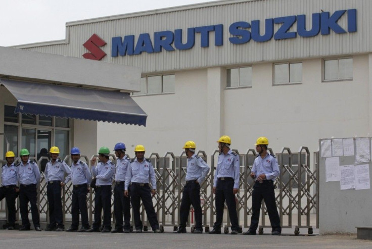 Private security guards stand outside the main entrance to the Maruti Suzuki India Limited plant where workers are striking in Manesar.