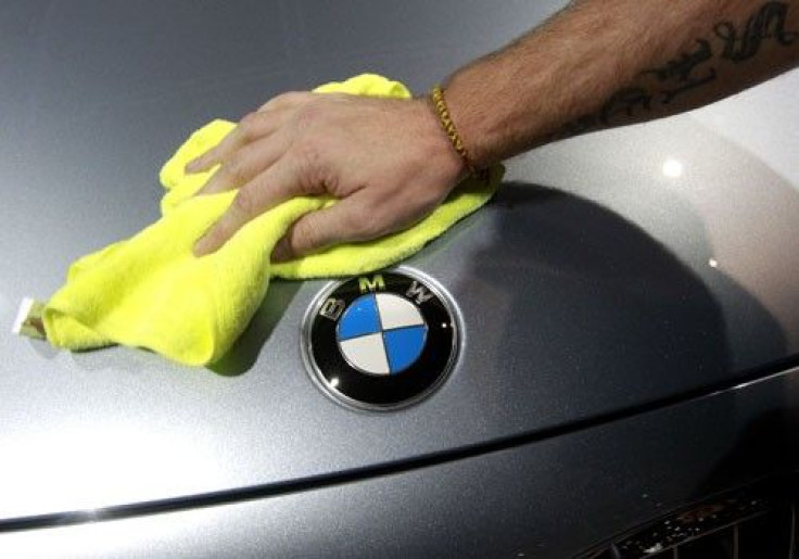 An employee cleans a BMW car displayed on media day at the Paris Mondial de l'Automobile (Paris Auto Show) October 1, 2010